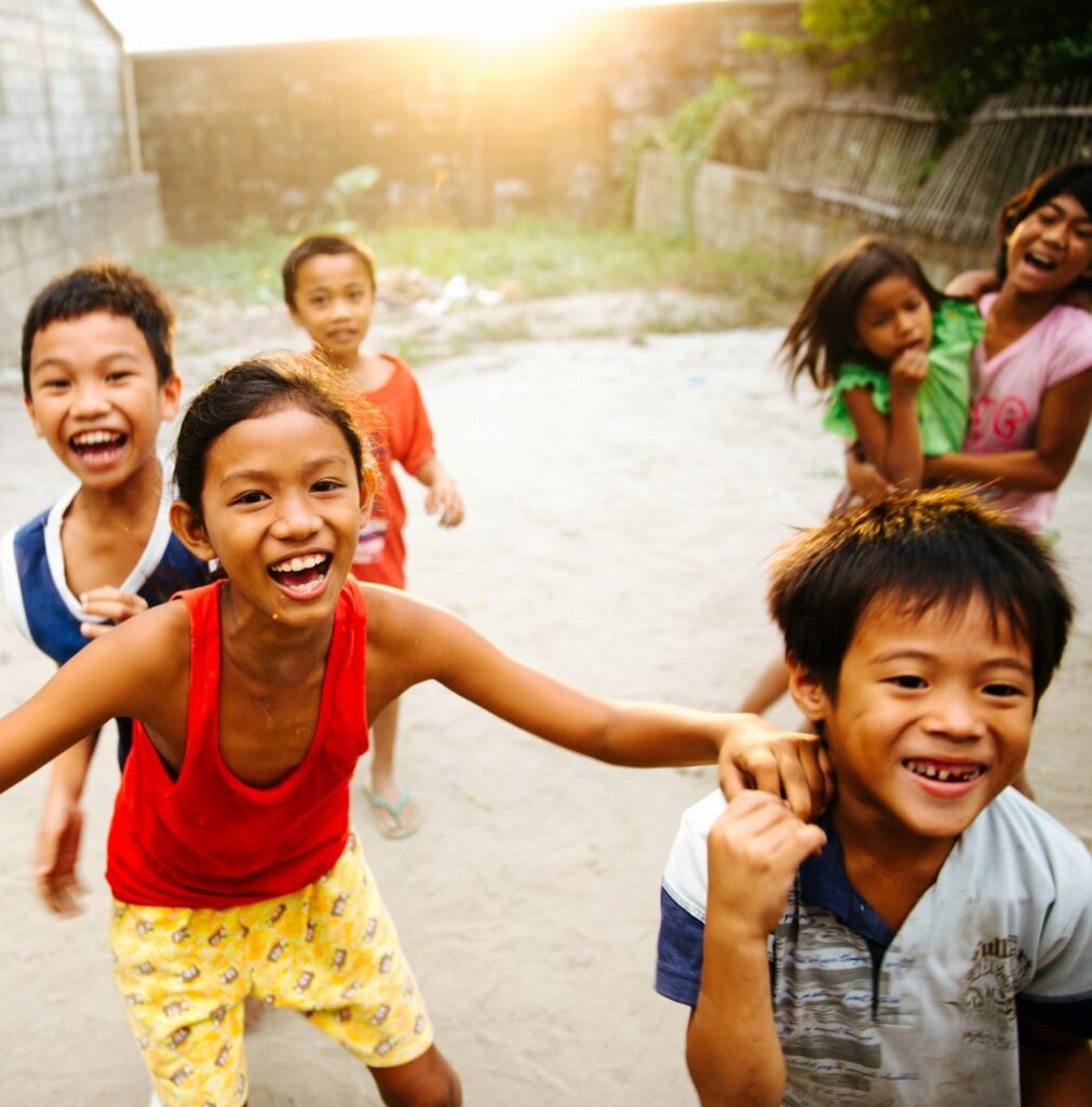 Happy children in Asia enjoying collaboration at Impact Playground