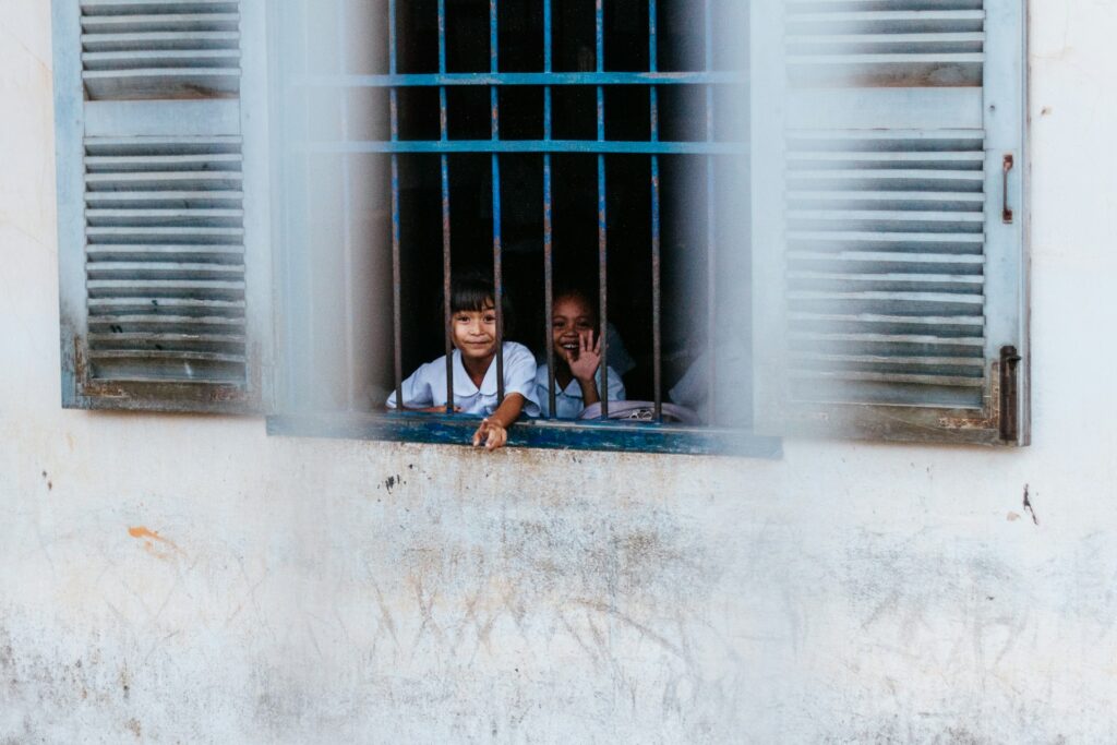 Kids behind the window. Impact Playground.