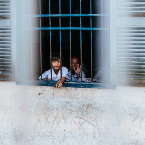 Kids behind the window. Impact Playground.